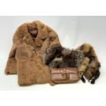 A three quarter length lined fur coat, together with two fox stoles, and a snake skin purse.