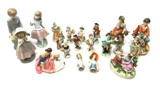 A group of assorted figurines, comprising a Royal Doulton figurine The Bedtime Story Hn2059, a pair