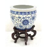 A large Chinese blue and white jardini�re decorated with a band of flowers and tendrils within styli
