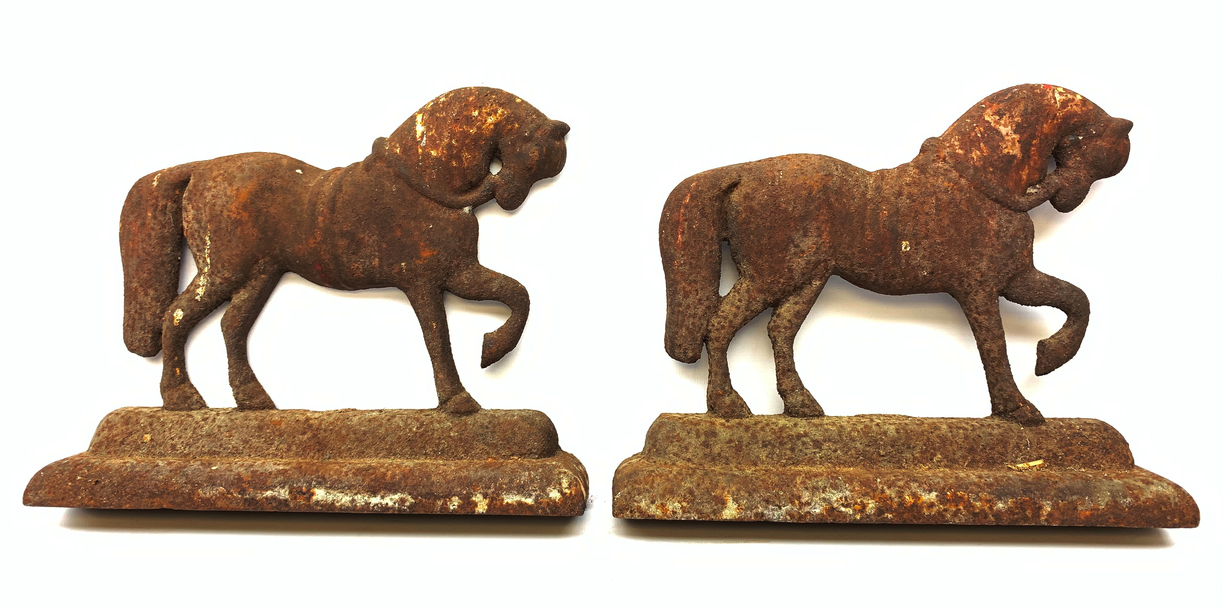 A pair of cast iron door stops, each modelled as a horse, H24cm L30cm.