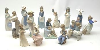 A group of thirteen Nao figurines, together with one Lladro figurine, each with printed mark beneath