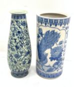 A Chinese blue and white umbrella stand, of cylindrical form decorated with birds perched upon bloss