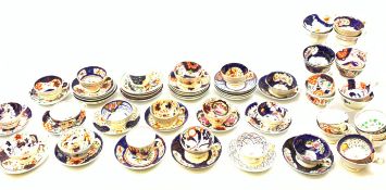 A large collection of assorted Gaudy Welsh style cups and saucers, each decorated with various flor