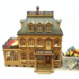 A child's Playmobil Victorian mansion dolls house, together with a good selection of accompanying p