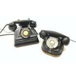 A Vintage black Bakelite telephone, together with another vintage metal bodied example with Bakelit