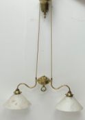 An early 20th century brass twin branch rise and fall light fitting, with opaque glass shades.
