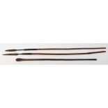 Two tribal hunting spears, one example with bamboo cane, each approx L111cm, together with a club.