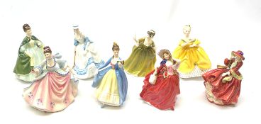 A group of Royal Doulton figurines, comprising Top O' The Hill HN1834, Autumn Breezes HN1934, The L