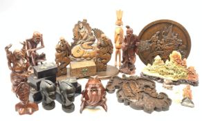 A selection of carved Eastern and African wooden figures and plaques, together with a set of five C