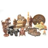 A selection of carved Eastern and African wooden figures and plaques, together with a set of five C