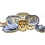 A selection of blue and white pottery, comprising four meat platters, a Victorian drainer, two tur