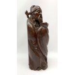 A carved Chinese hardwood figurine, modelled as a sage, H41cm.