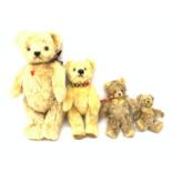 A group of four teddy bears, to include a small Steiff example with button to ear, and a Chad Valle