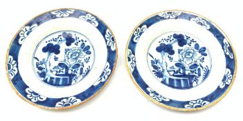 A pair of late 18th century/early 19th century blue and white Delft plates, of circular form decorat