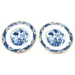 A pair of late 18th century/early 19th century blue and white Delft plates, of circular form decorat