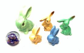 Five Sylvac Rabbits, to include a large example marked 1026, etc., together with a Caithness glass
