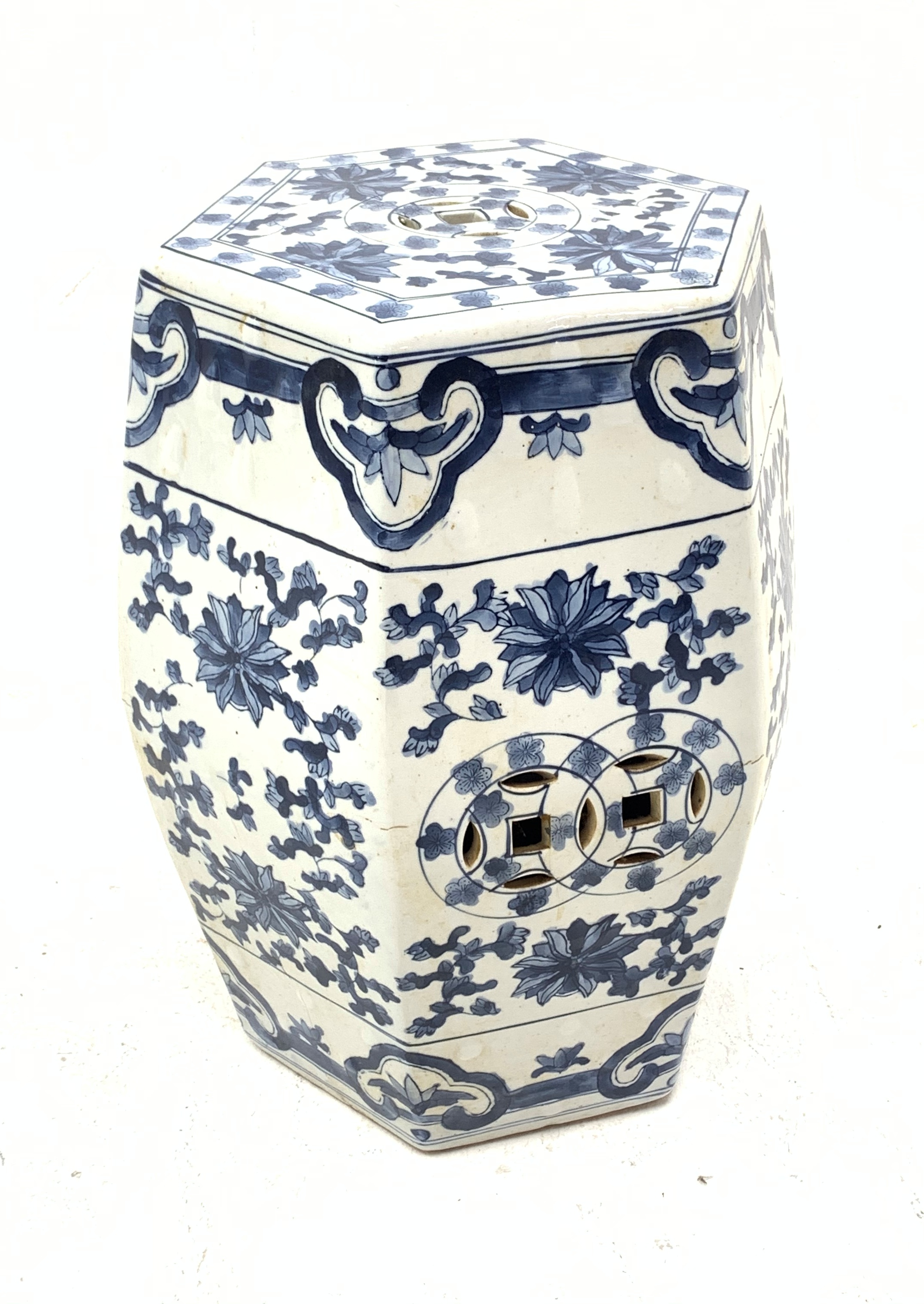 A Chinese blue and white garden seat, of hexagonal barrel form, decorated with stylised flowers, H48