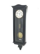 Early 20th century ebonised Vienna type wall clock, shaped pediment over arch glazed door, circular