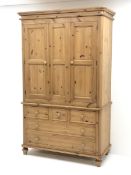 Waxed pine wardrobe enclosed by two panelled doors on chest fitted with three small and two long dra