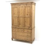 Waxed pine wardrobe enclosed by two panelled doors on chest fitted with three small and two long dra