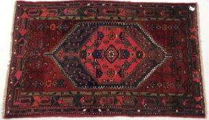 Afghan hand knotted red ground rug, diamond centre with geometric pattern, 195cm x 122cm