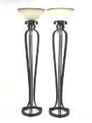 Pair of black painted metal floor standing uplighter lamps, each of skeletal form with three cluster