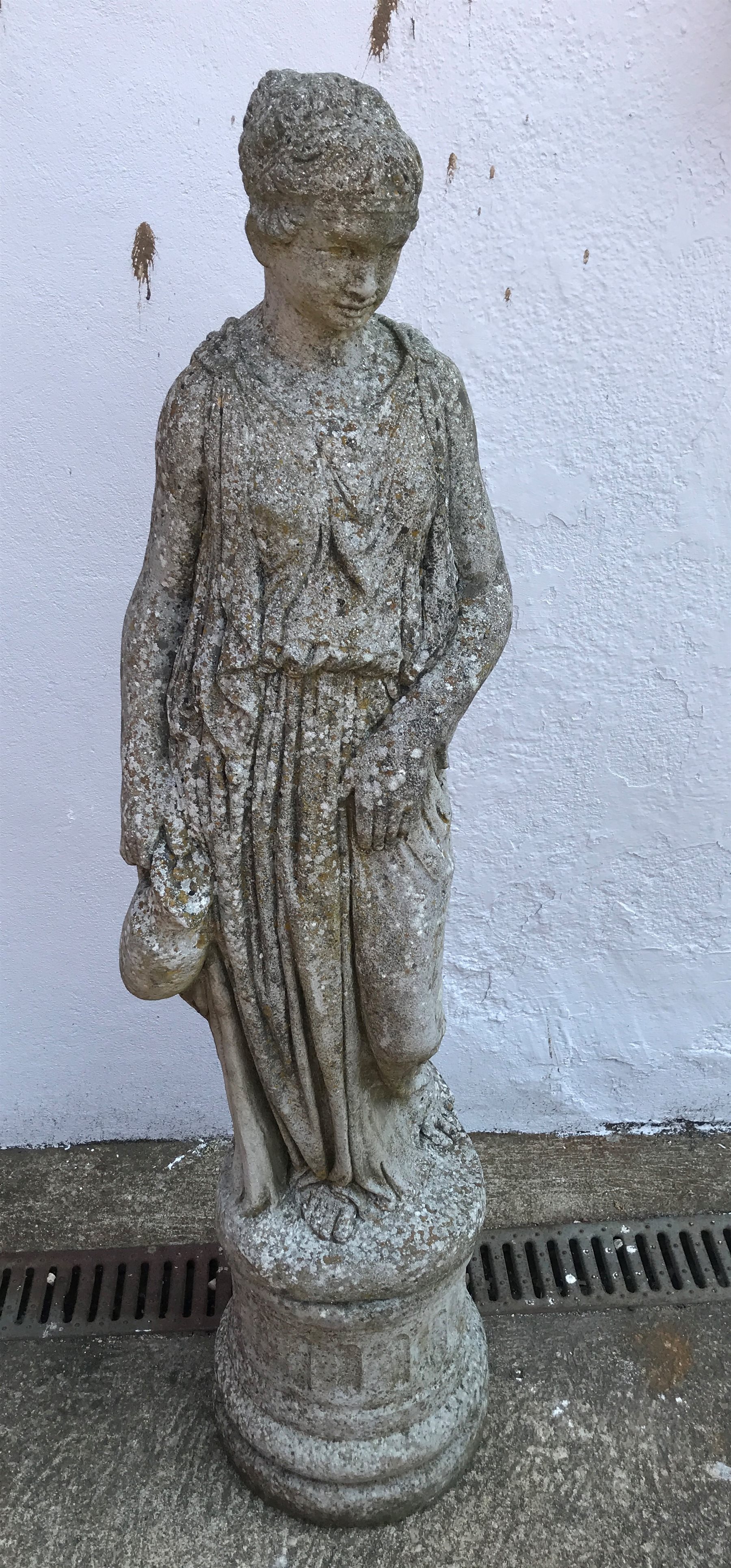 Composite stone figure of classical style woman carrying jug on plinth, H99cm