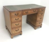 Mid 20th century walnut twin pedestal desk, three piece inset leather top, nine drawers, shaped pli