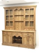 Traditional pine dresser fitted with three drawers and four cupboard doors, complete with glazed dis