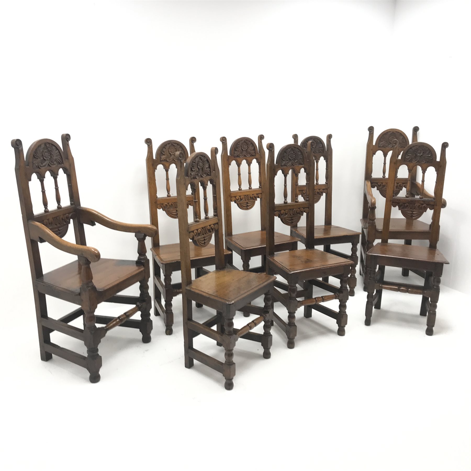 Set eight (6+2) early 20th century oak dining chairs, floral carved cresting rail, solid seat, turn