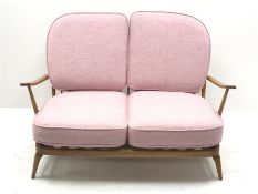 Ercol 'Windsor' beech frame two seat sofa with loose cushions upholstered in pink fabric, W134cm