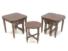 Two walnut nest of tables, each table with two smaller nesting tables with foldout bases, on turned