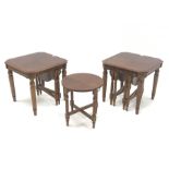 Two walnut nest of tables, each table with two smaller nesting tables with foldout bases, on turned