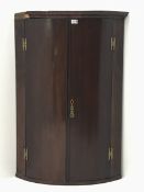 George III mahogany bow corner cabinet, two doors enclosing three shelves, W74cm, H107cm
