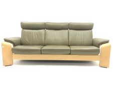 Stressless three seat light wood framed reclining sofa, upholstered in green leather with adjustable
