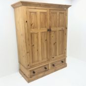 Light oak display cabinet, projecting cornice, two doors enclosing glazed shelves above two drawers