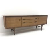 Mid 20th century Younger teak sideboard, two cupboards flanking three graduating drawers on tapering