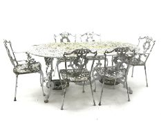 Ornate cast alloy garden table decorated with scrolls and foliage (186cm x 95cm, H72cm), and set si