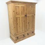 Solid pine double wardrobe, projecting cornice, two doors enclosing hanging rail above two drawers,