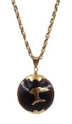 Gold mounted kukui nut pendant, on gold chain with barrel clasp stamped 9c