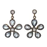 Pair of blue topaz and diamond, daisy design pendant earrings
