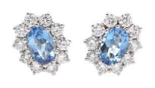 Pair of 18ct white gold aquamarine and diamond cluster stud earrings, hallmarked, aquamarine total w