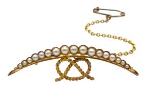 Edwardian gold split pearl half crescent and knot brooch, stamped 15ct