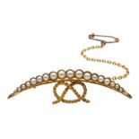 Edwardian gold split pearl half crescent and knot brooch, stamped 15ct