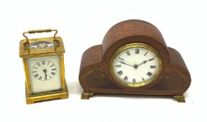 A brass cased carriage clock with carry handle, the white enamel dial with black Roman numerals, exc