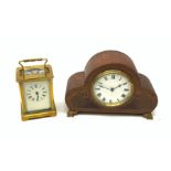 A brass cased carriage clock with carry handle, the white enamel dial with black Roman numerals, exc