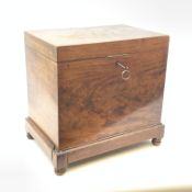A 19th century mahogany box, with hinged opening cover, raised upon four squat bun feet (a/f), H41.5