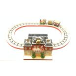 A Villeroy & Boch porcelain Christmas table decoration, modelled as a railway station with track, en