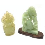 Chinese carved Jade model of Buddha and a green stone carved figure of a fish amongst lotus stems an