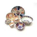 A group of Victorian teawares, comprising four cups, five bowls, and one plate, each decorated with